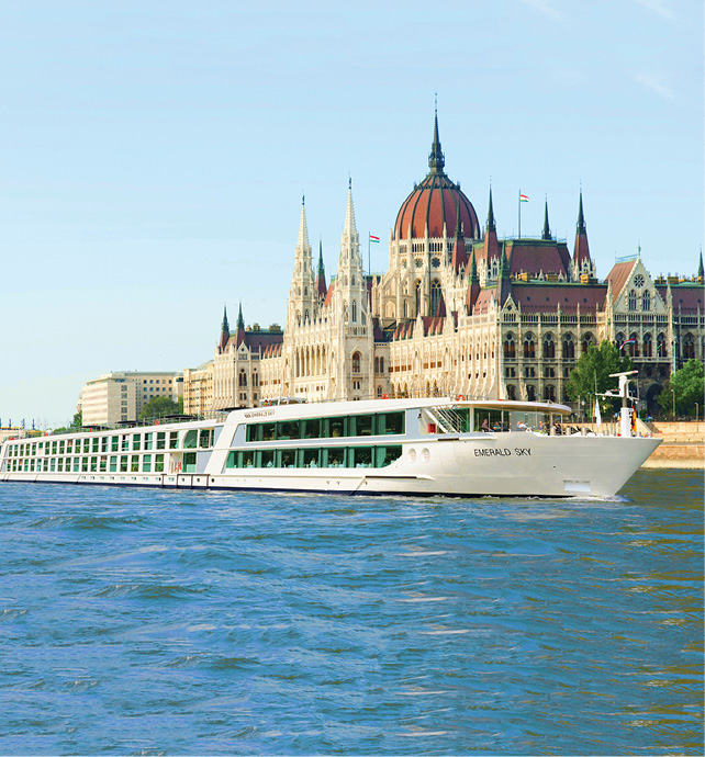 A river ship passing by a grand building