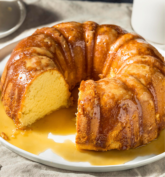 round bunting cake with a hole in the middle covered with rum sauce