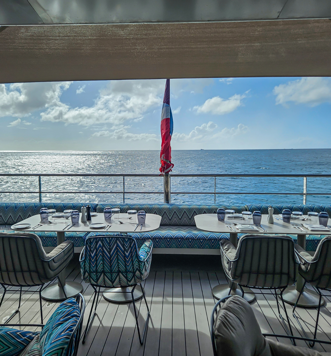 Yacht deck with dining setting overlooking ocean view