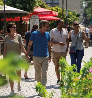 People walking down cobbled European street