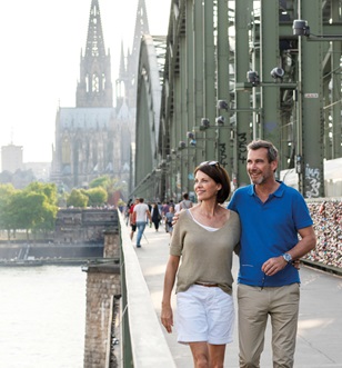 A couple walking over Hohenzollern Bridge in Cologne Germany