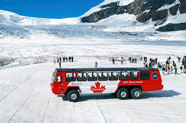 Canadian bus taking passengers up to snowy mountains
