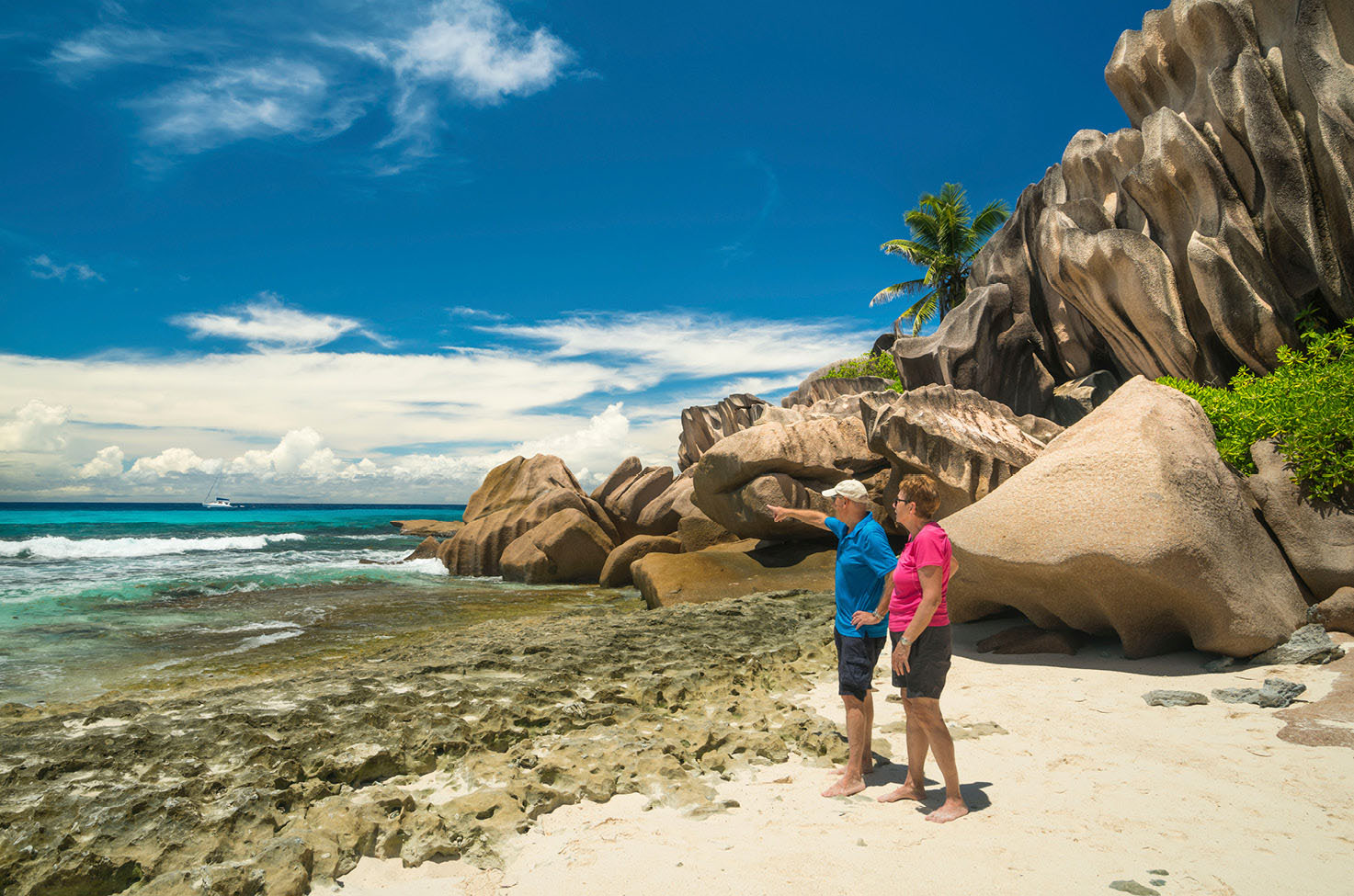 two people standing on a beach