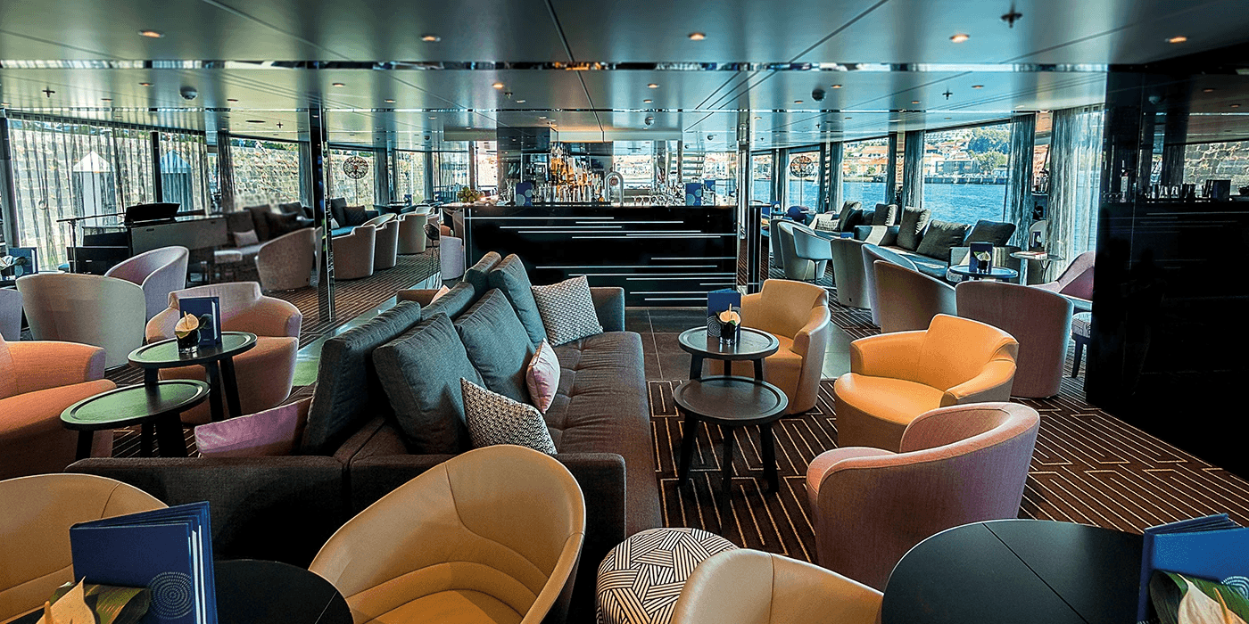 Modern and stylish bar and lounge area on board a luxury river ship sailing the Mekong in Southeast Asia