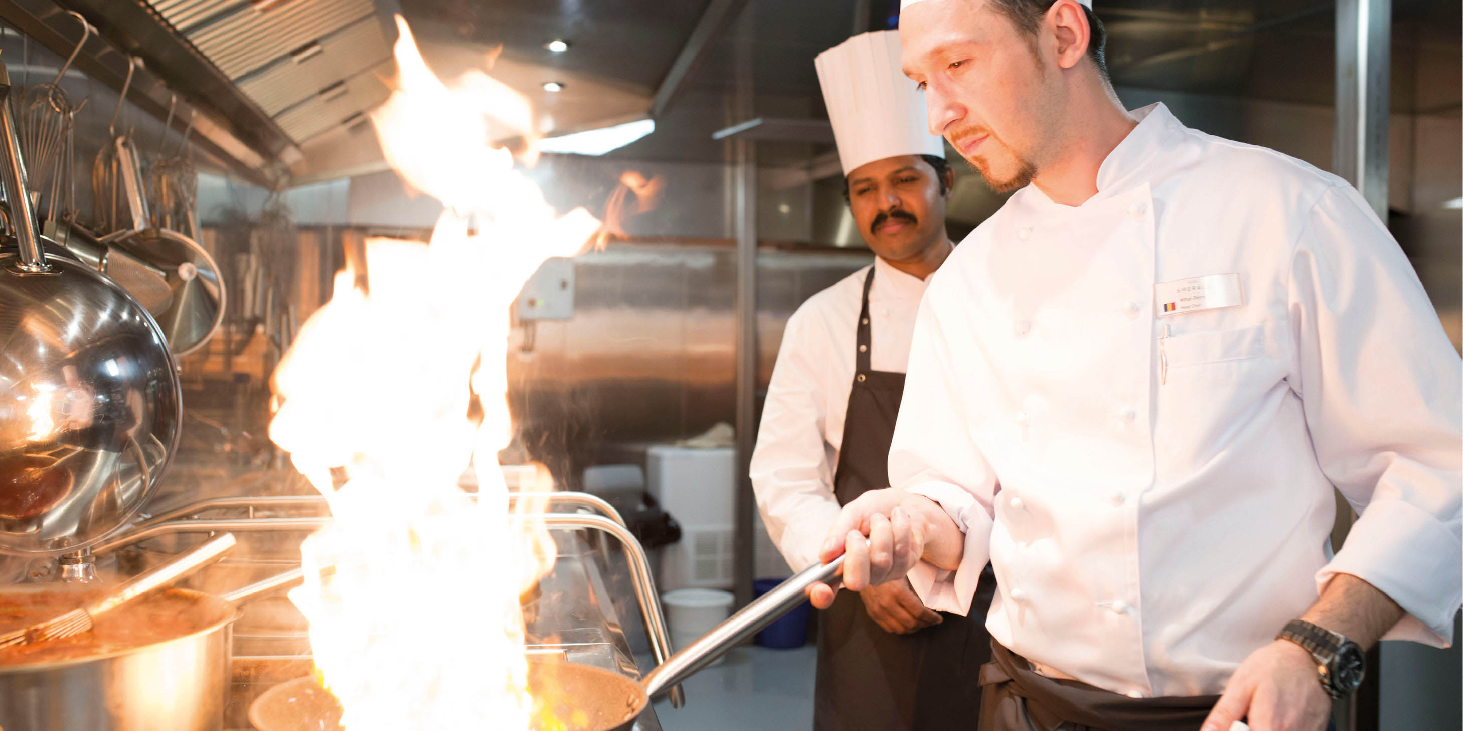 Two chefs preparing a delicious meal for guests on board a luxury river ship in Europe