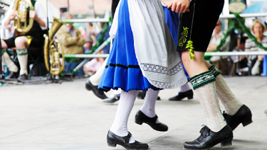 Bavarian couple dancing wearing traditional clothes
