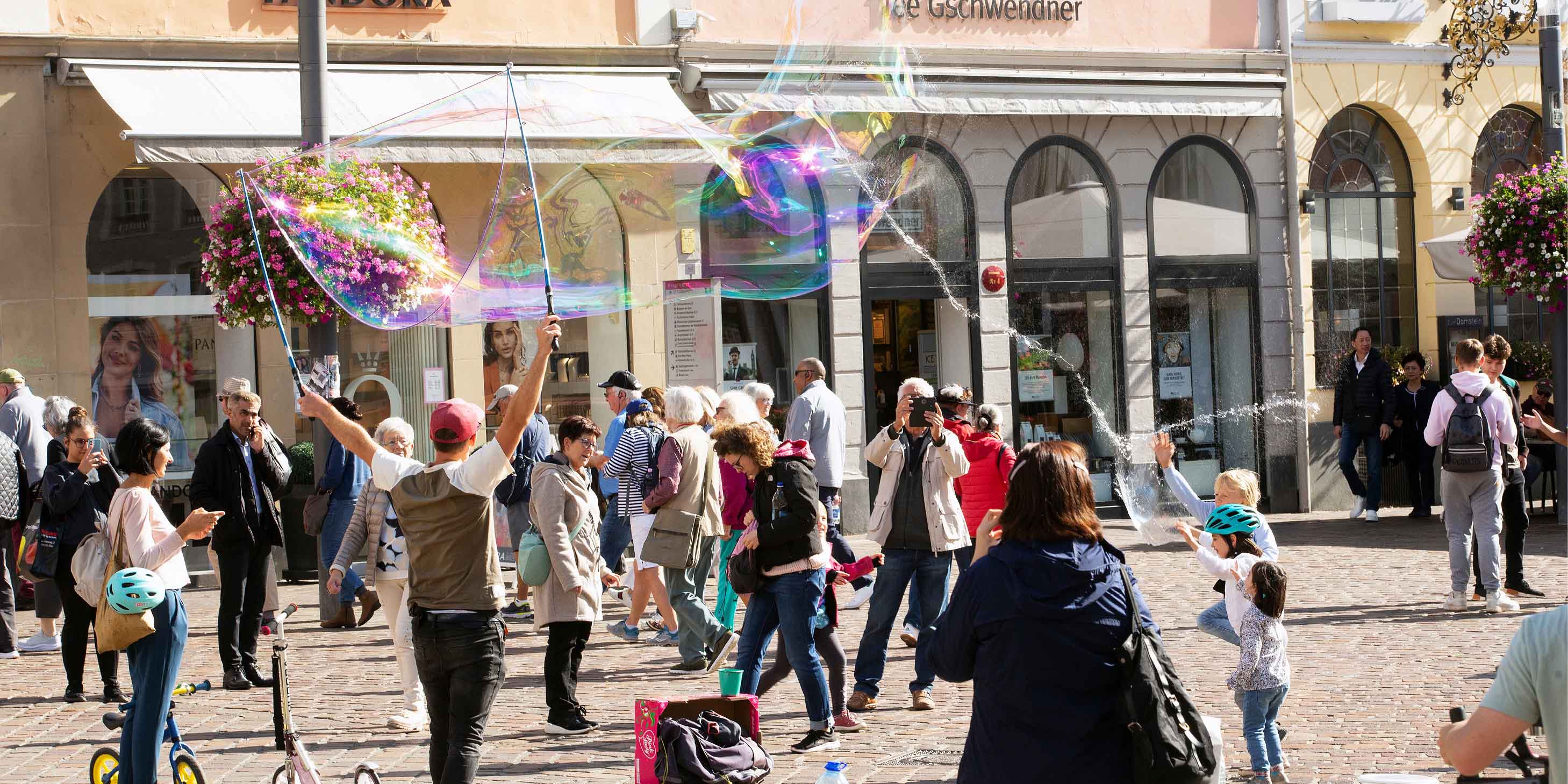 Street performers and crowd gathering in Trier, Germany