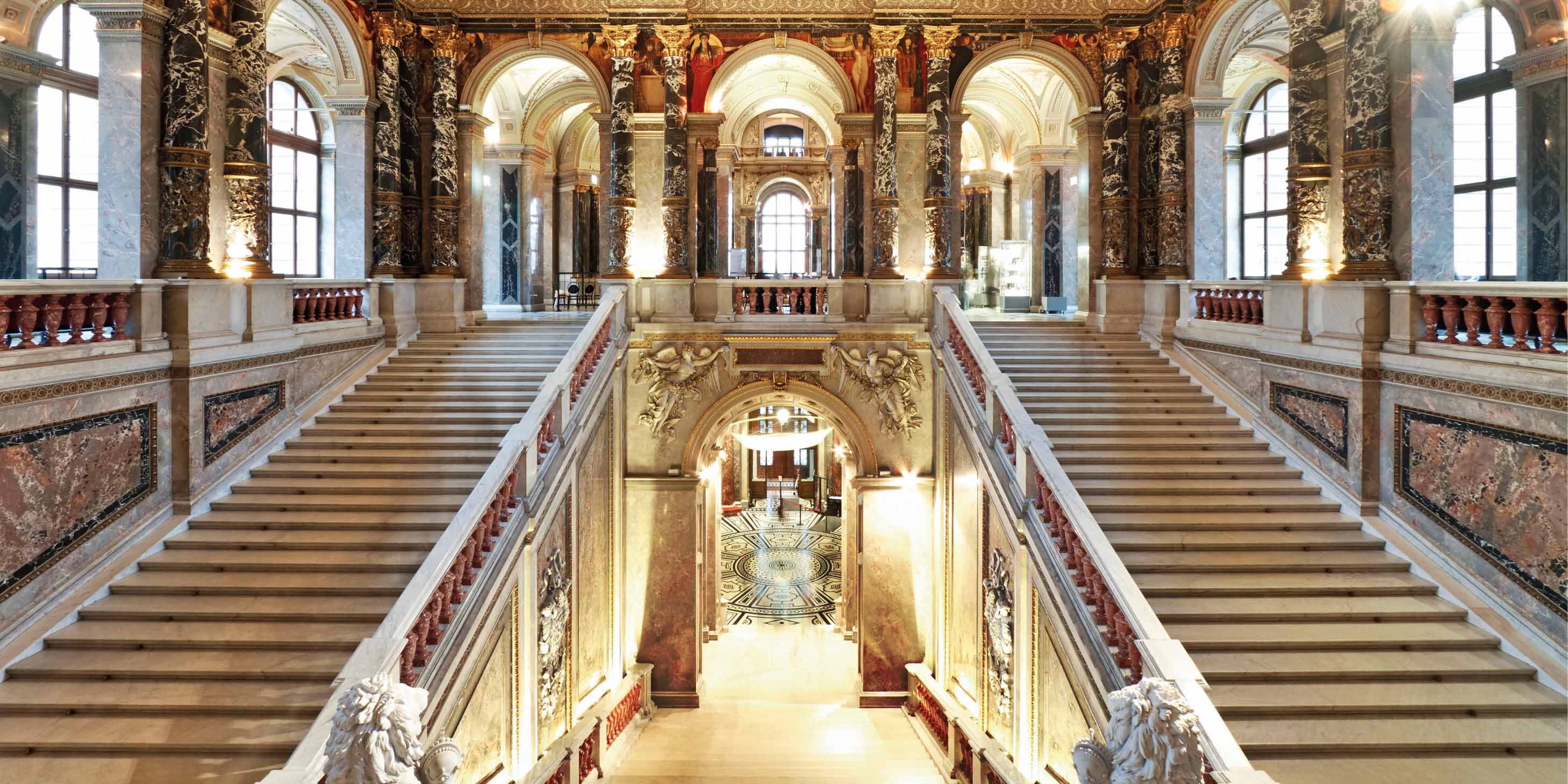 The grand staircases, archways, and ceiling of Kunsthistorisches Museum located in Vienna, Austria