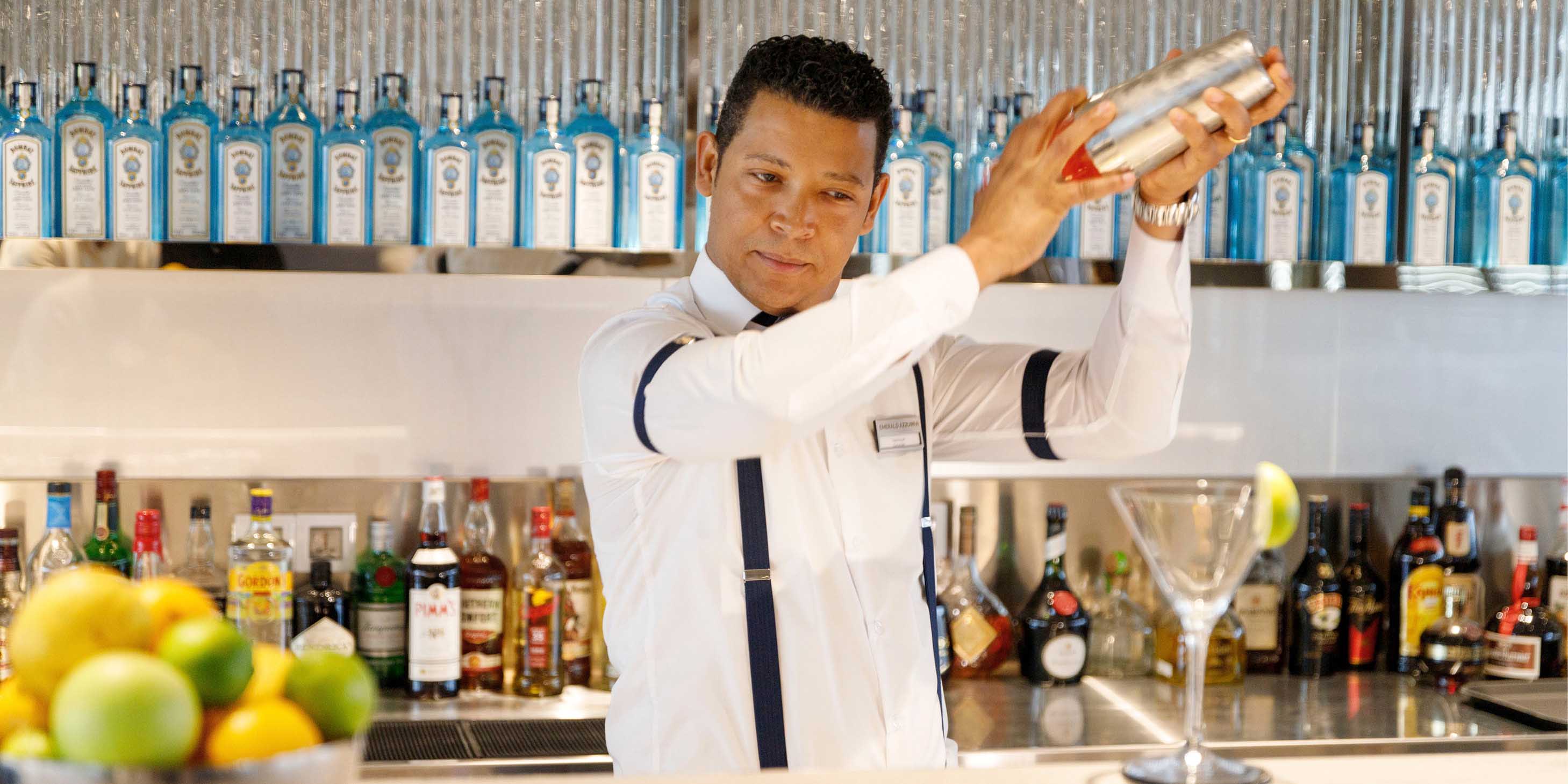 Bartender mixing up a delicious cocktail on board a luxury yacht