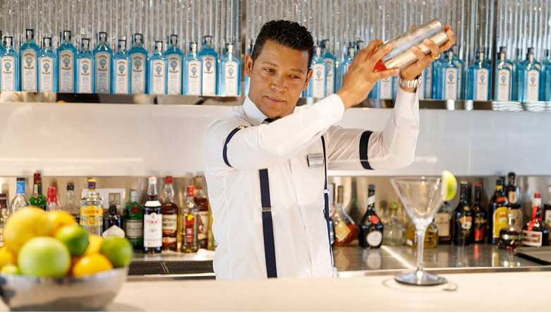 Bartender mixing up a delicious cocktail on board a luxury yacht