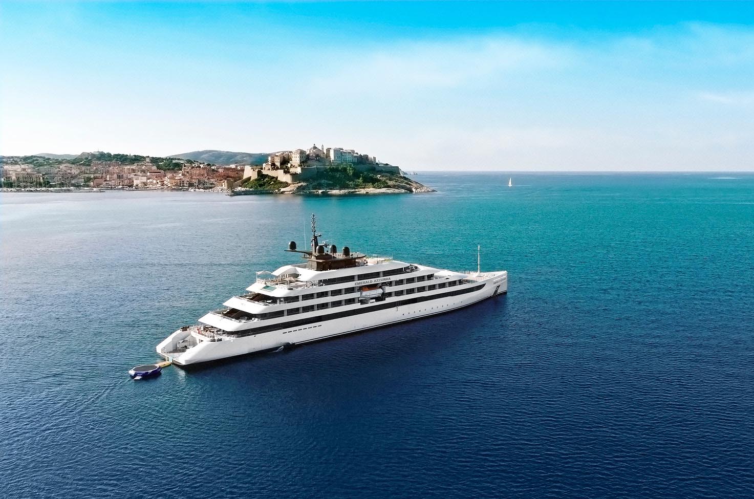 An Emerald Cruises yacht sailing in the blue waters of Calvi, Corsica, France