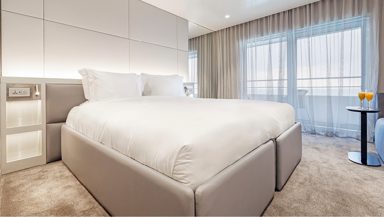 A spacious balcony suite cabin with private balcony on an Emerald Cruises yacht