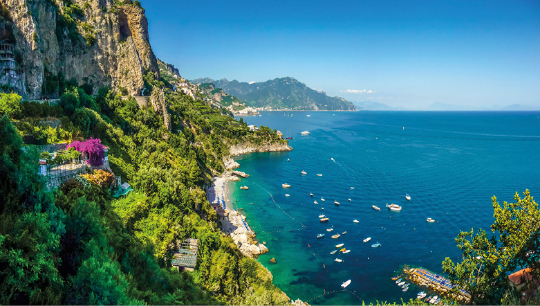 Amalfi Coast, Gulf of Salerno, with blue sea, blue sky, and green hills and cliff faces